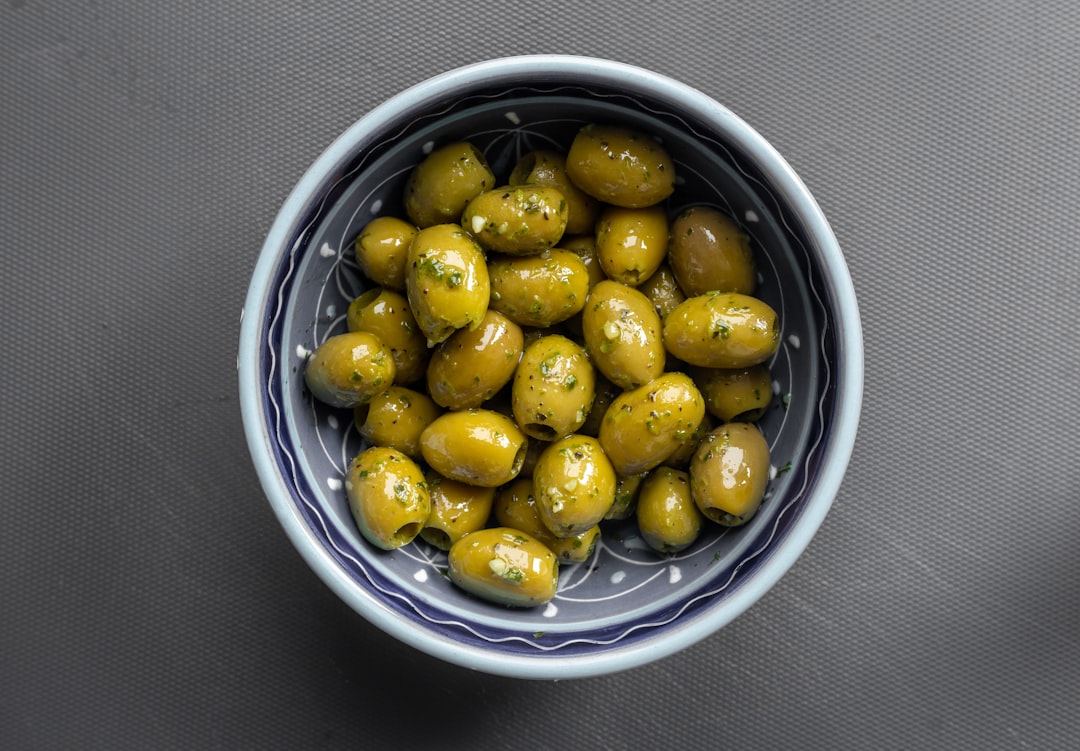 yellow round fruits in blue ceramic bowl