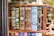 A bookshelf showcasing a collection of classic literature with ornate book covers. Featured titles include works by Fitzgerald, Lovecraft, Doyle, Shakespeare, Carroll, and Stoker. The covers are elaborately designed, with some featuring illustrations like a keyhole and an image of Alice from Alice's Adventures in Wonderland.