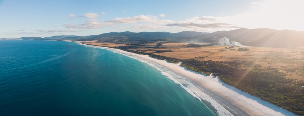 aerial view of sea and mountain during daytime