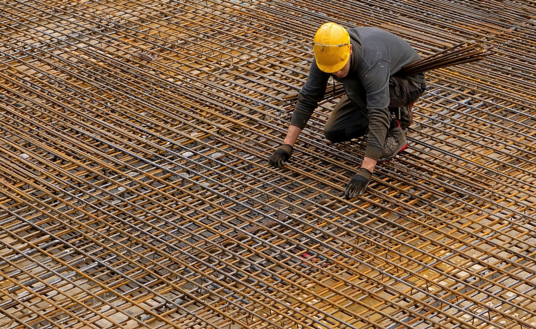 man in black jacket and yellow helmet, Steel man at work