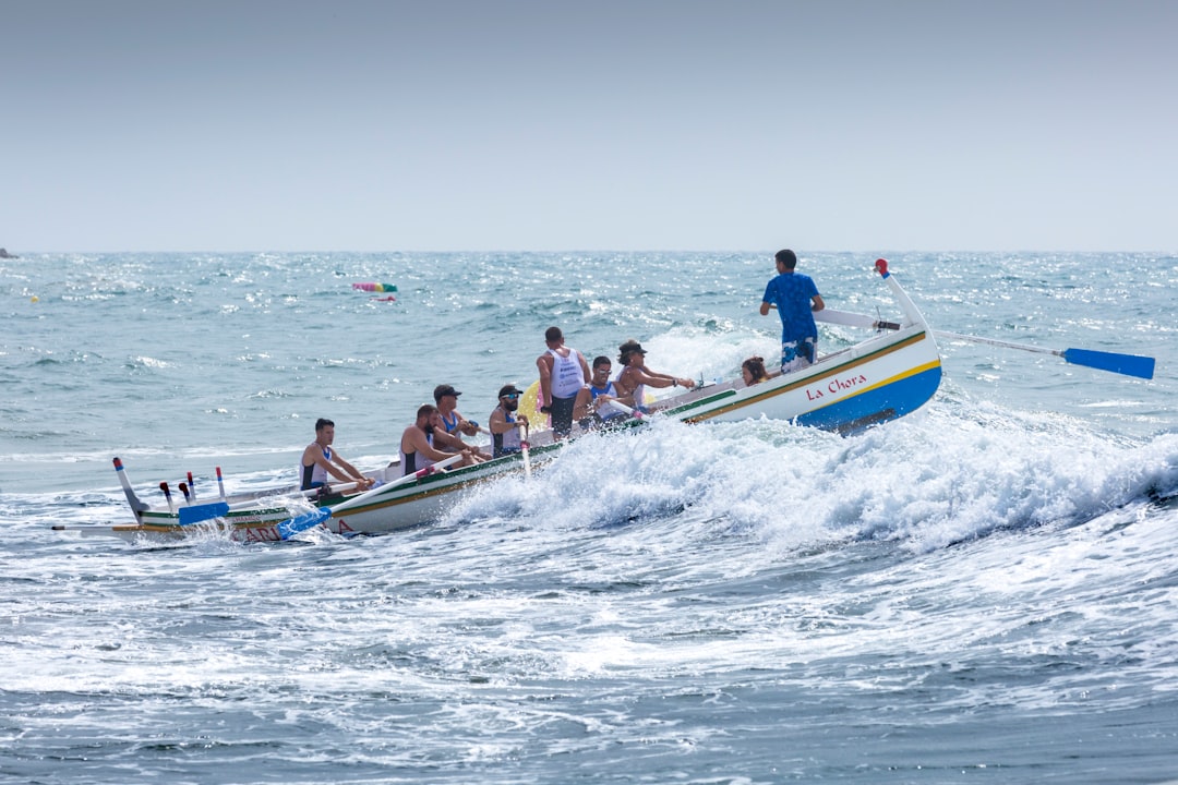 people riding on blue and yellow boat during daytime