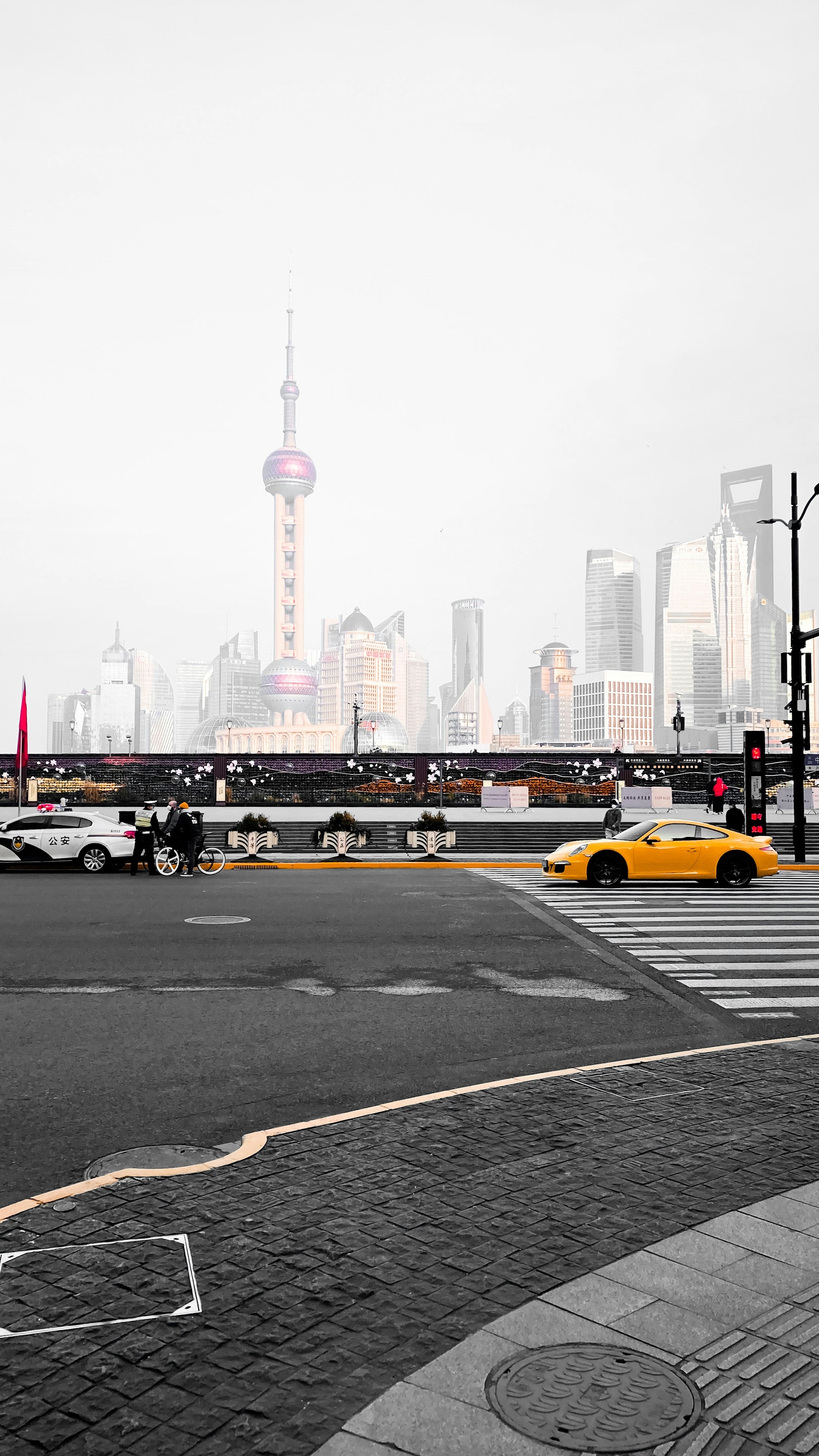 yellow taxi on road near city buildings during daytime