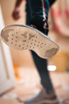 person wearing brown and white shoe