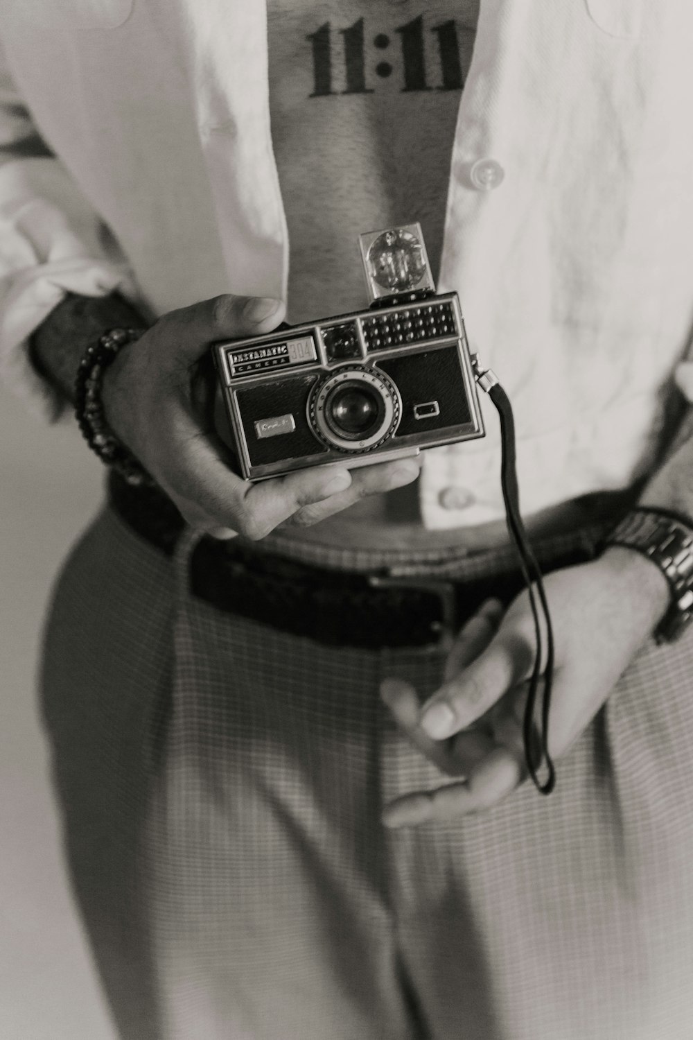 person holding black and silver camera