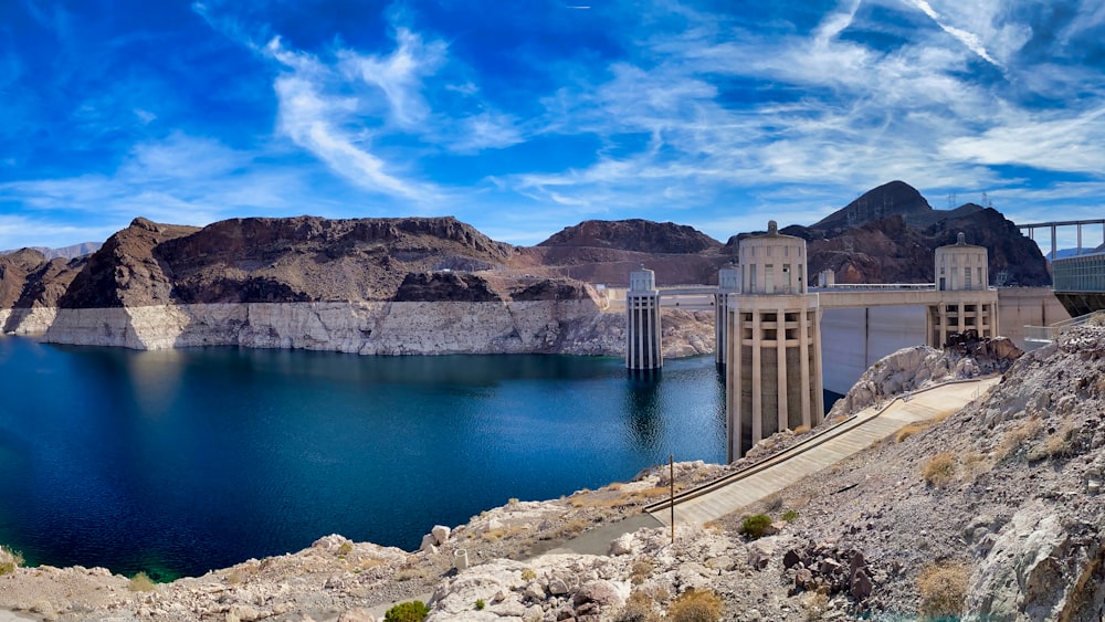 white concrete building near body of water under blue sky during daytime