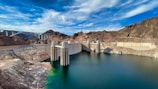 gray concrete dam under blue sky during daytime