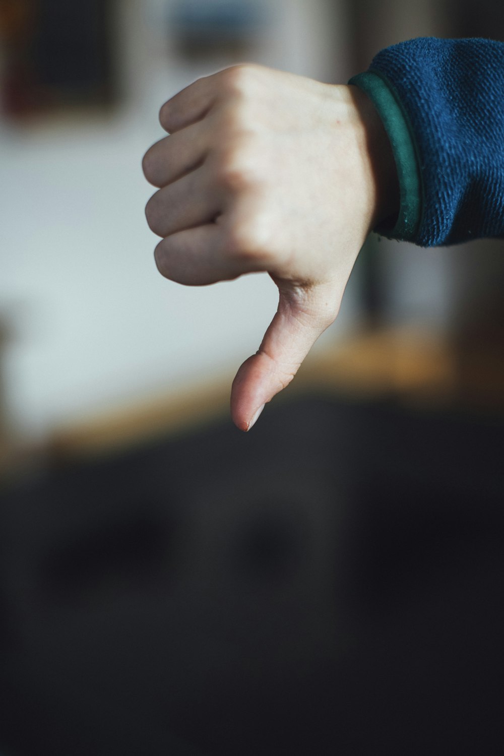 person in blue long sleeve shirt showing right hand