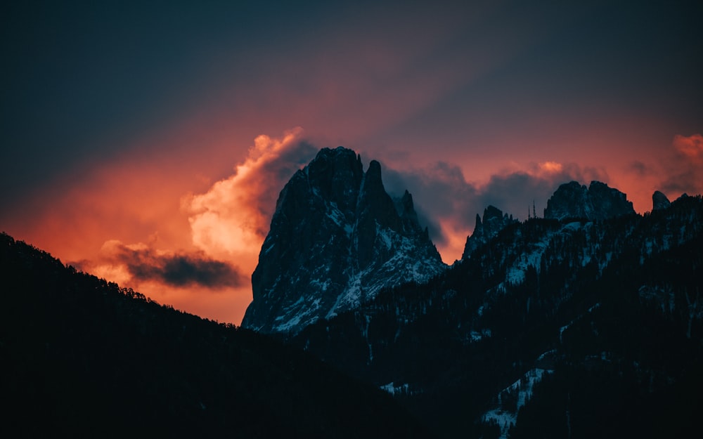 rocky mountain under cloudy sky during daytime