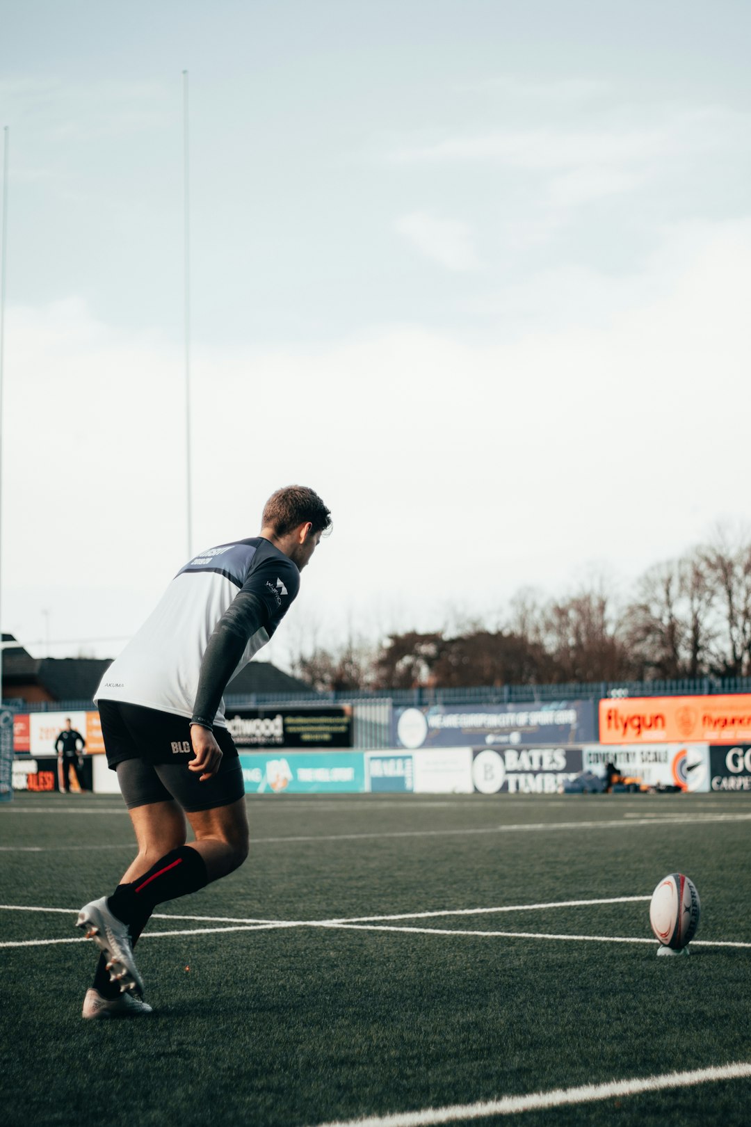 man in black and white nike jersey shirt playing soccer during daytime