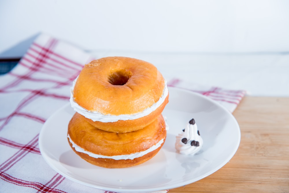brown doughnut on white ceramic plate
