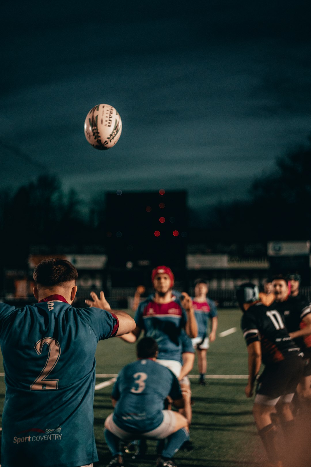 group of men playing soccer during nighttime