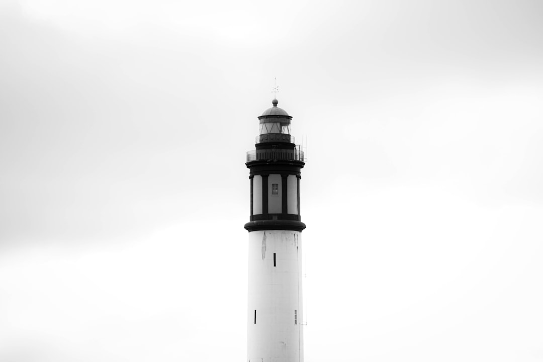 white and black lighthouse under white sky