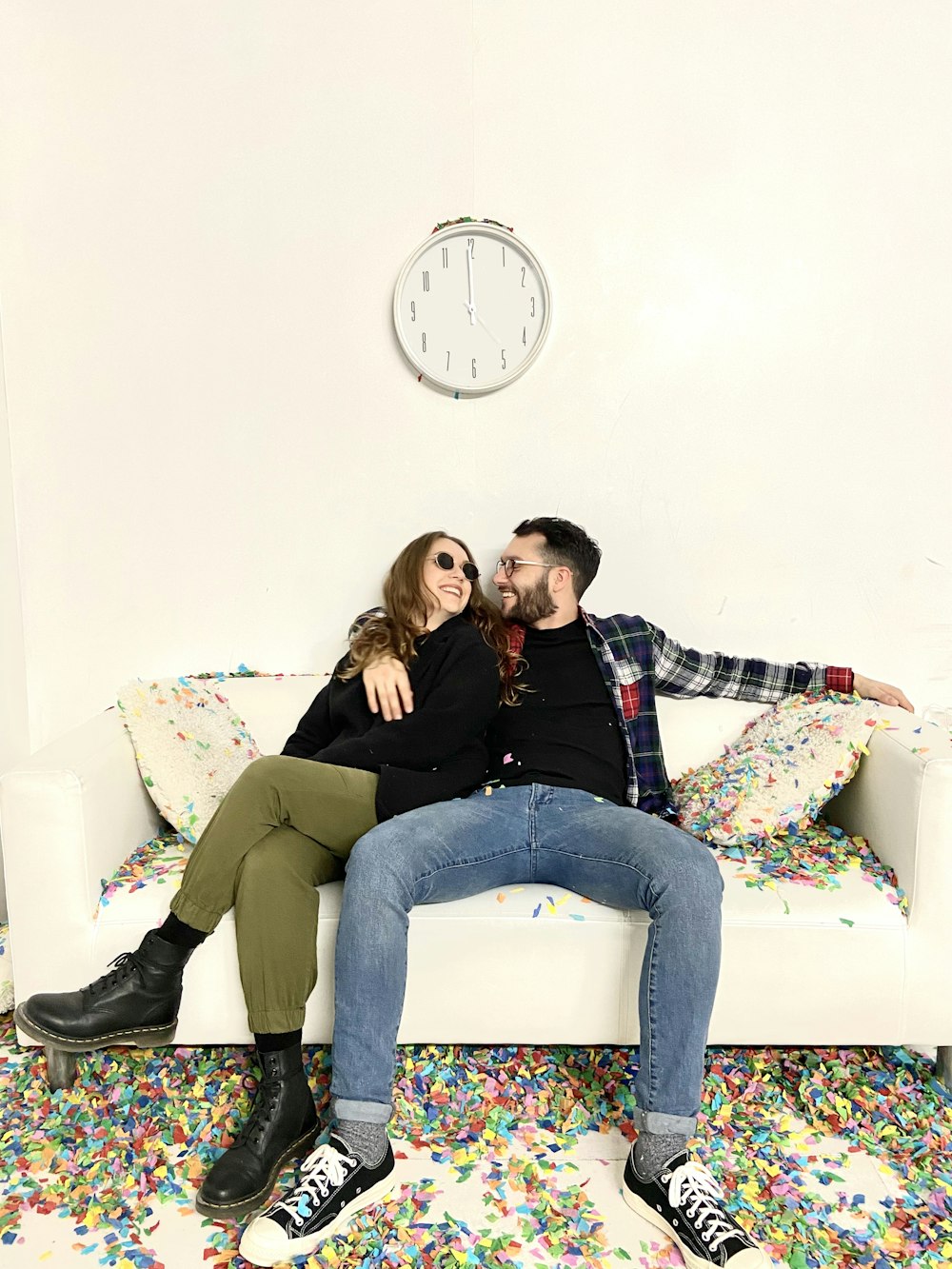 woman in black jacket and gray pants sitting on white couch