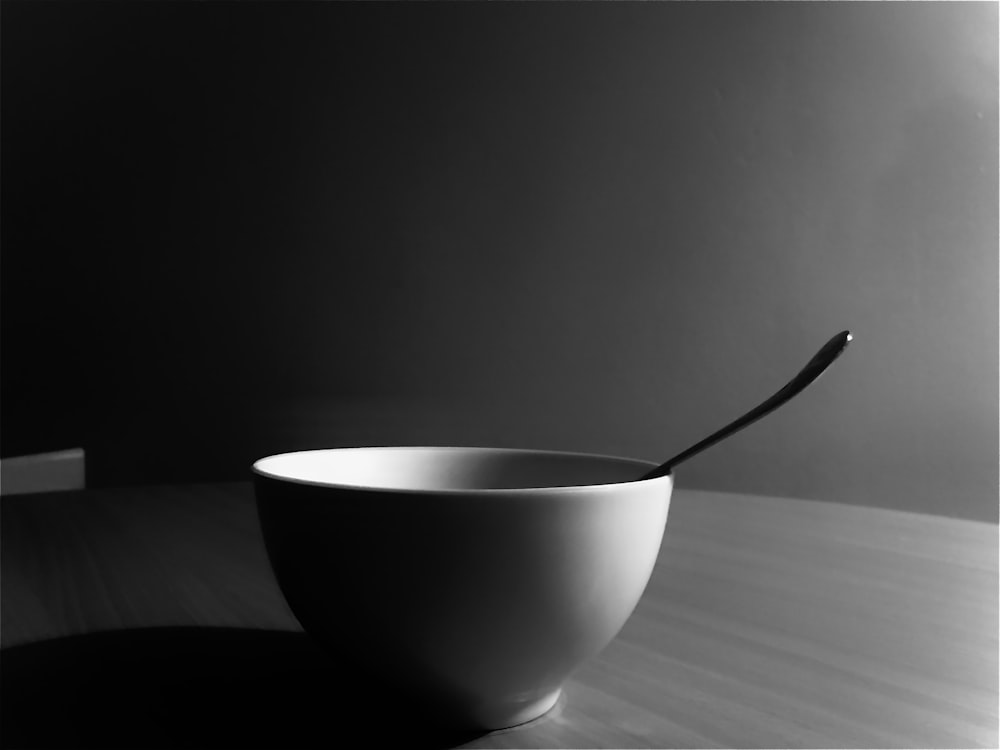 white ceramic bowl with silver spoon