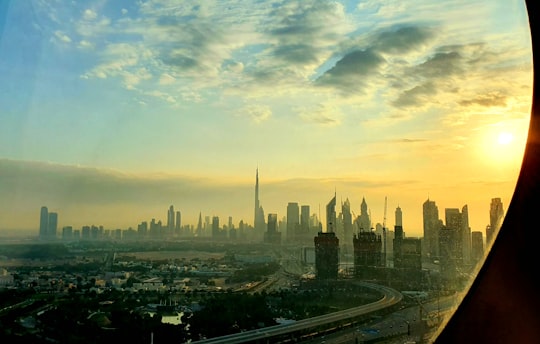 city skyline under white clouds during daytime in Dubai Frame United Arab Emirates