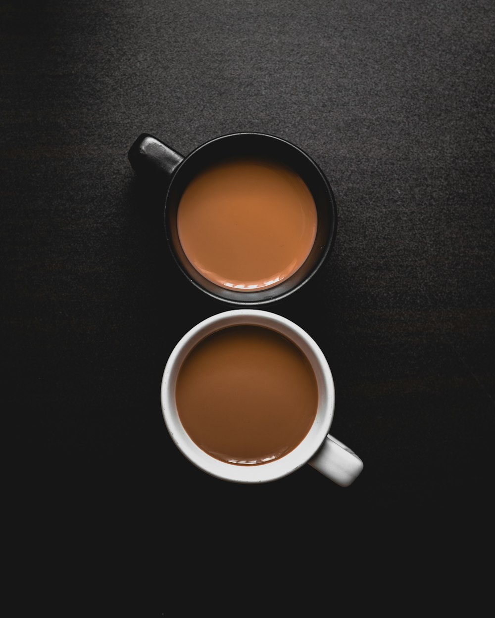 white ceramic mug with brown liquid