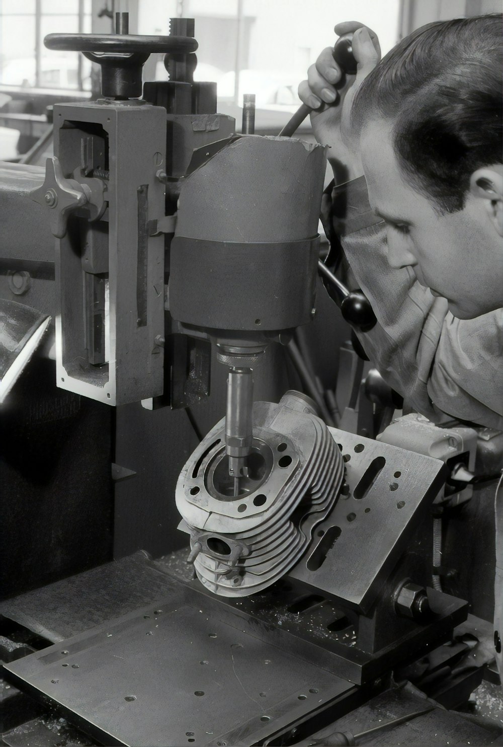 man in white dress shirt using gray and black power tool