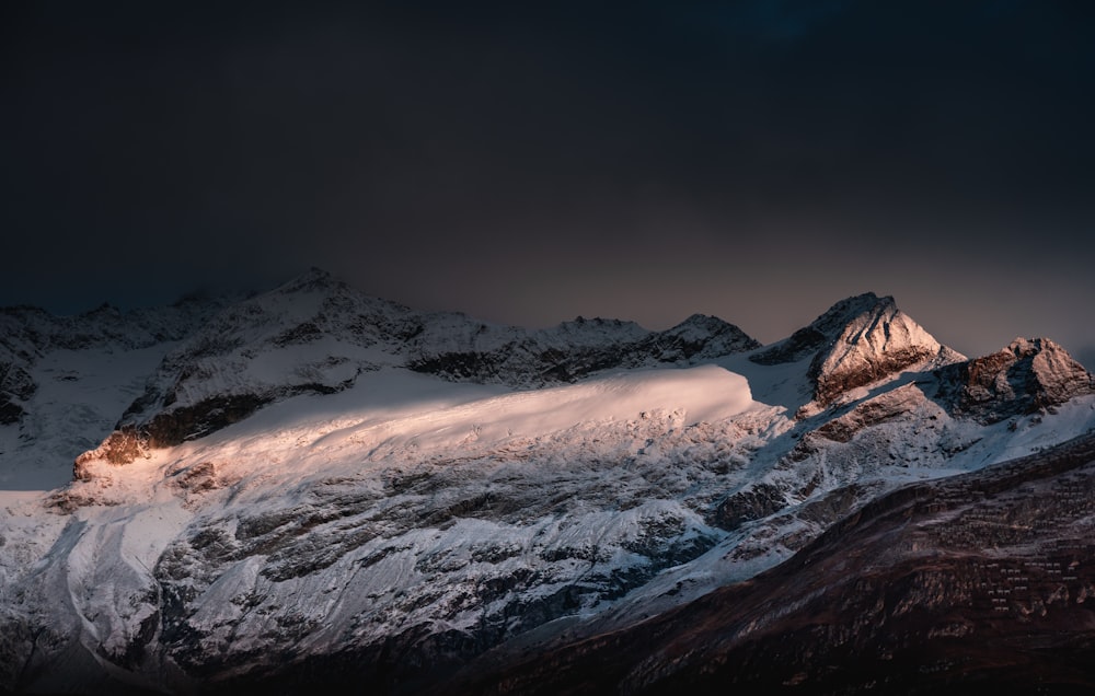 snow covered mountain during daytime