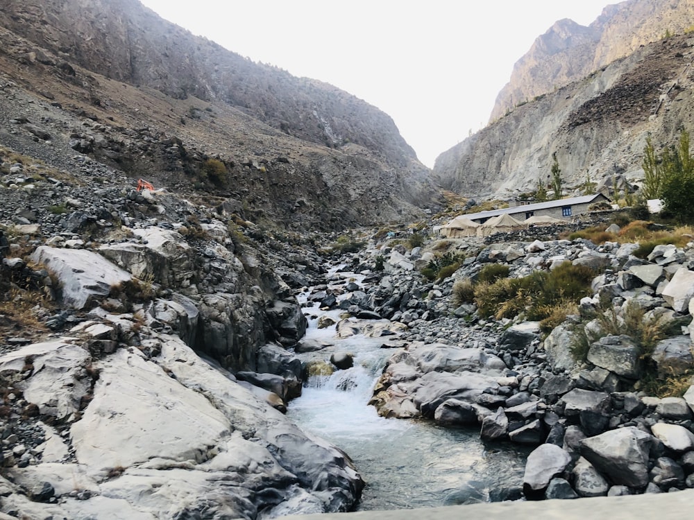 river between rocky mountains during daytime