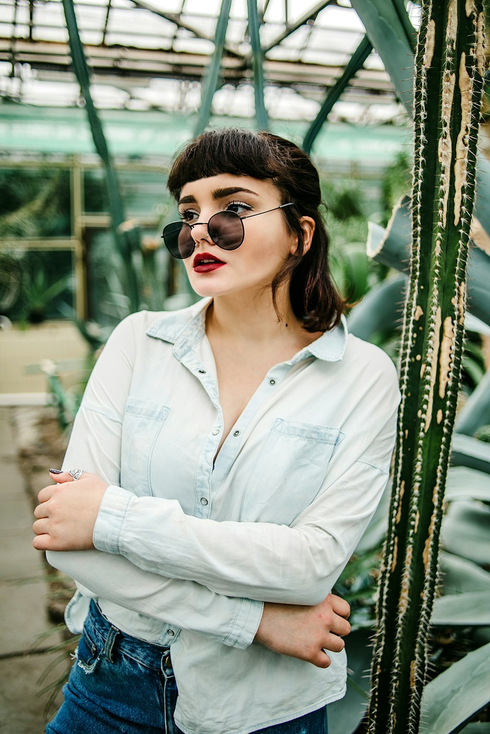 woman in white button up shirt wearing black sunglasses