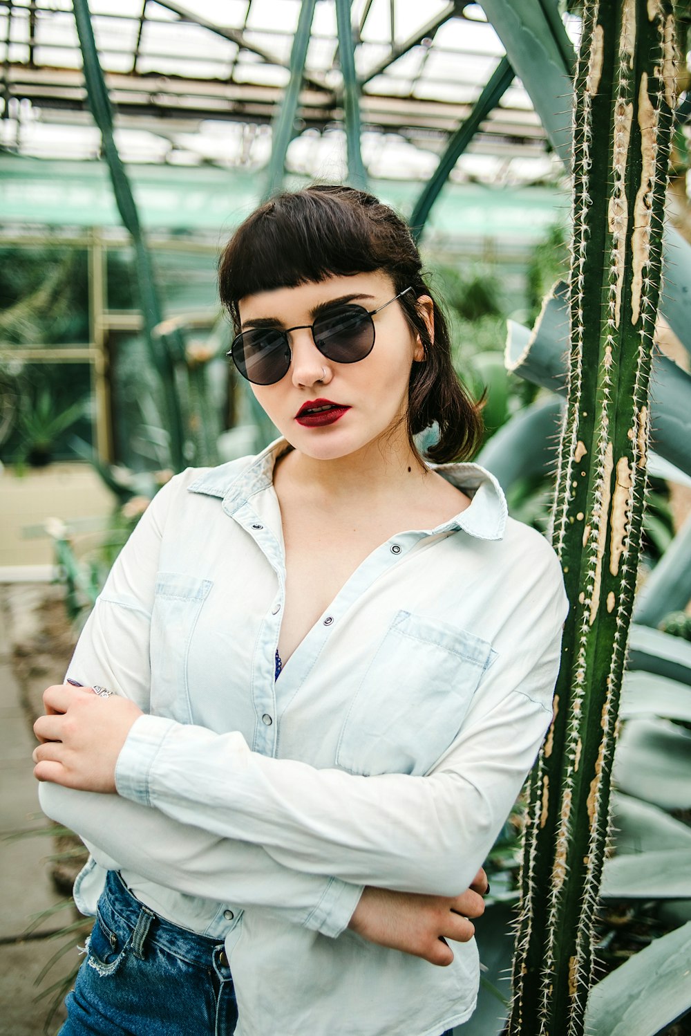 woman in white button up shirt wearing black sunglasses