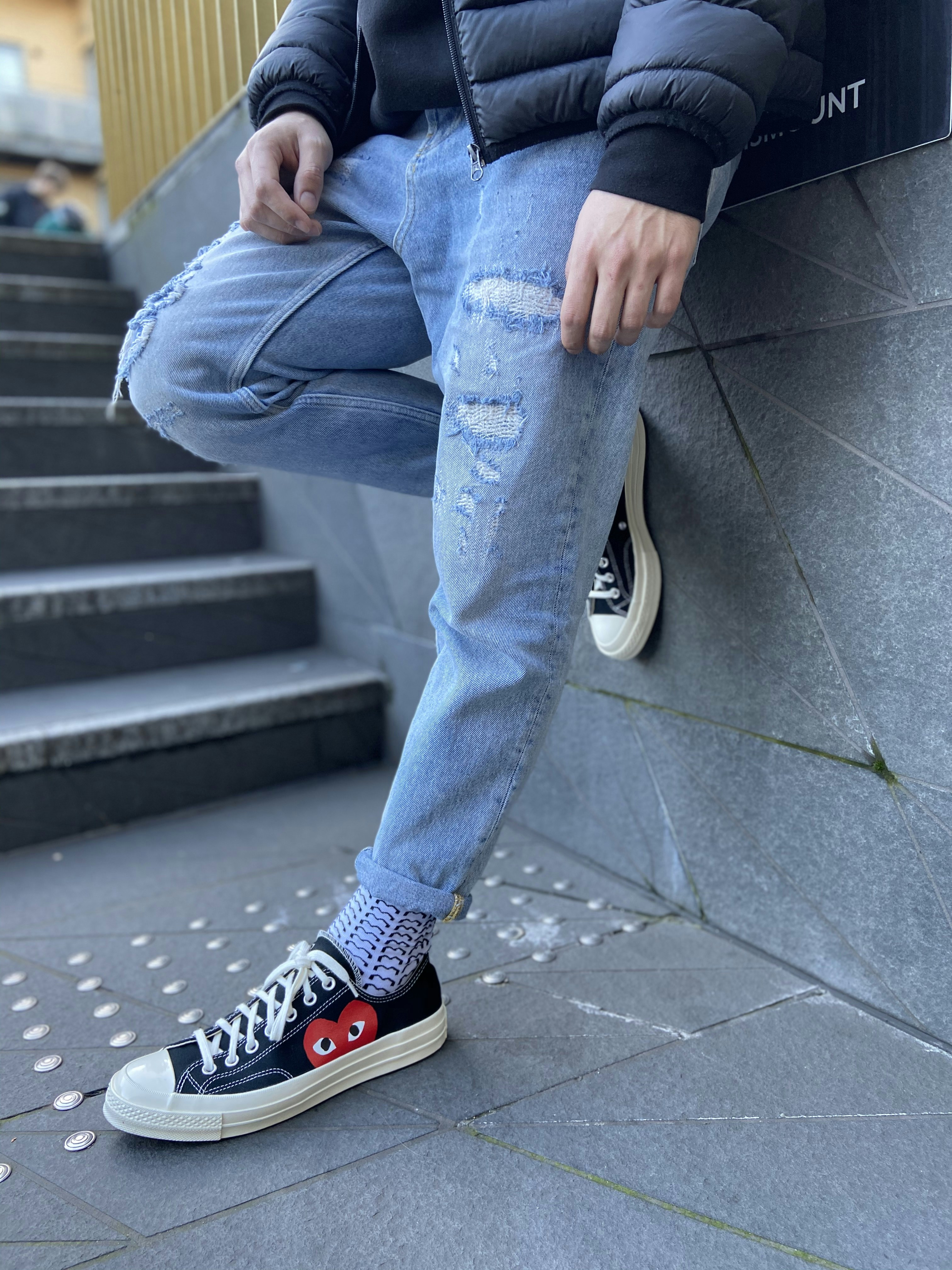 person in blue denim jeans and black 