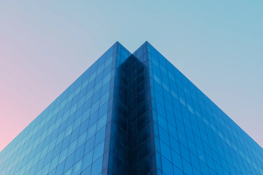Blue glass facade rising to a sharp apex