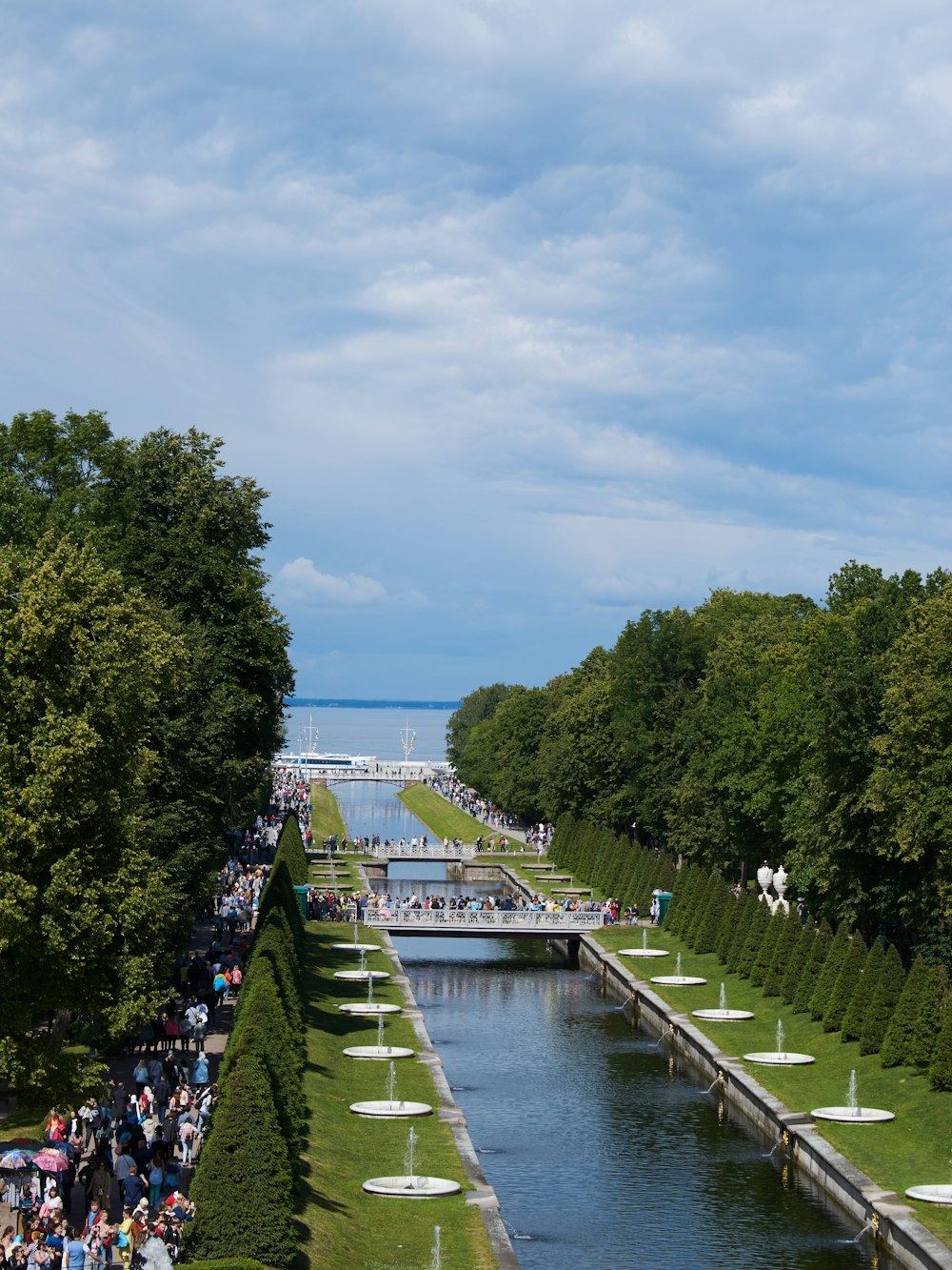 people walking on bridge over river during daytime