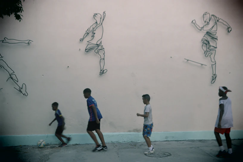 Children playing futsal joyfully on a community court in Planaltina.