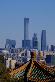 An archival photo of the Dattani family home in Hong Kong, showing traditional architecture blended with modern cityscape.