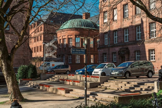 cars parked in front of brown building in Freiburg im Breisgau Germany
