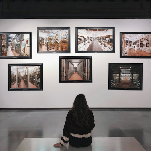A crowded museum gallery with visitors gathered closely around a display