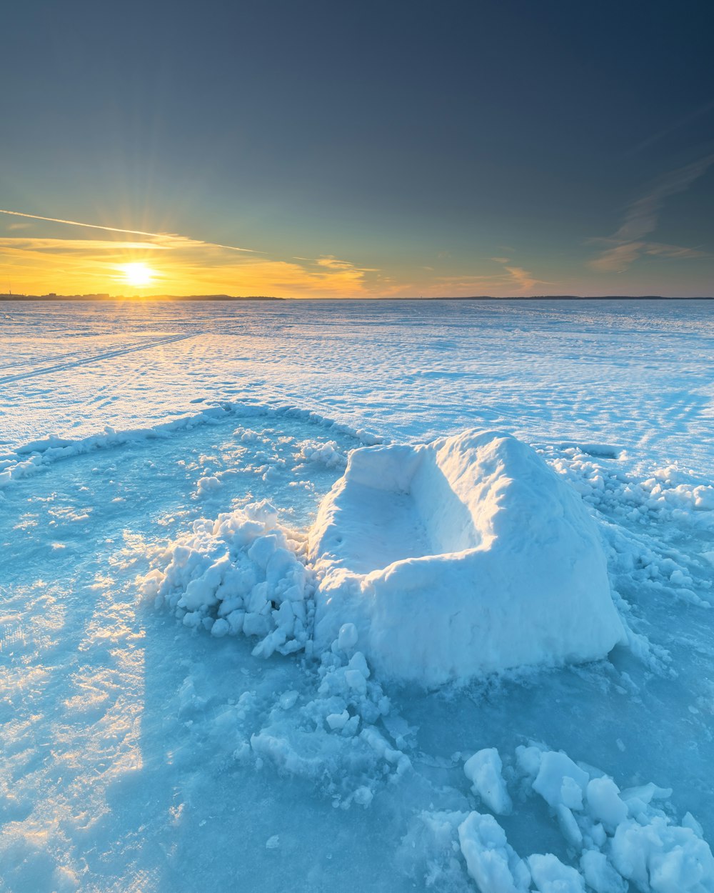 snow covered field during sunset