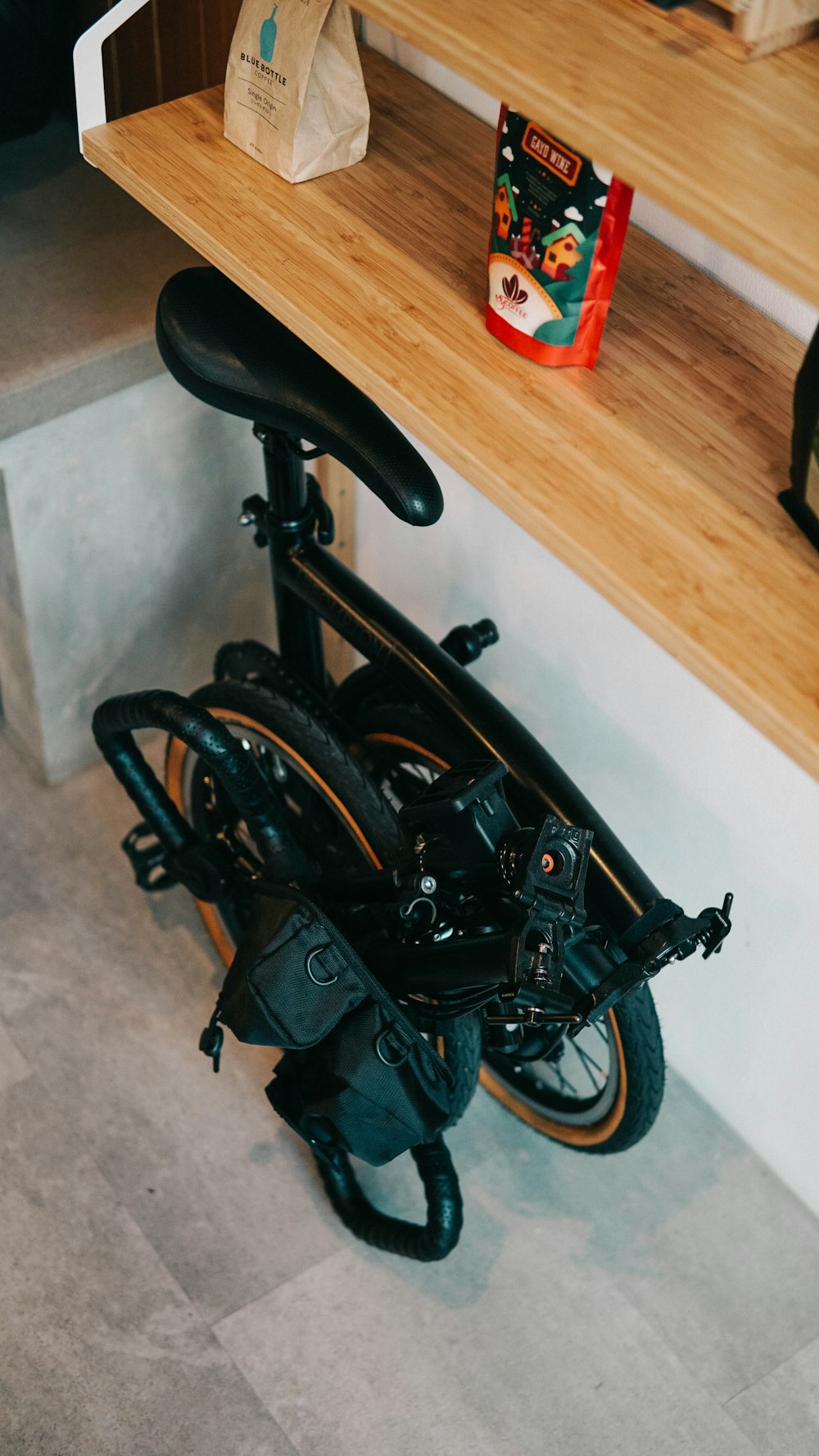 black and gray stroller on brown wooden floor