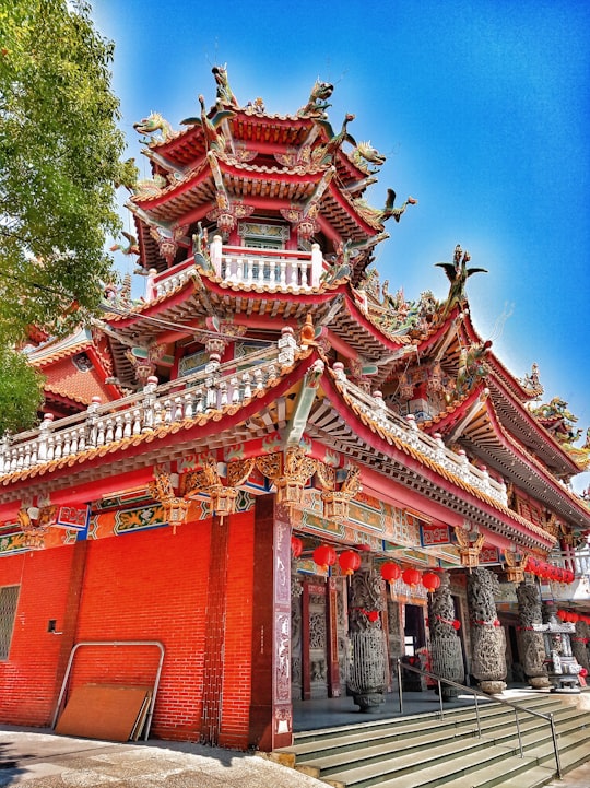 red and white temple under blue sky during daytime in Taijiang National Park Taiwan