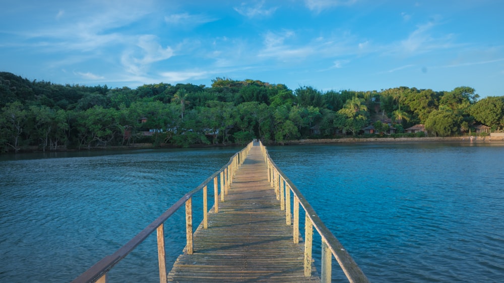 brown wooden dock on blue sea under blue sky during daytime