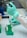person in white long sleeve shirt holding green and white labeled can