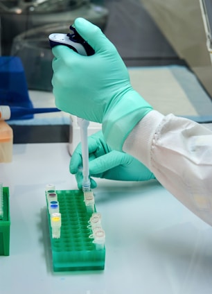A friendly lab technician carefully preparing a blood sample in a bright, clean laboratory.