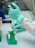 person in white long sleeve shirt holding green and white labeled can