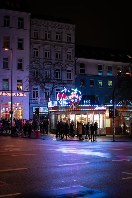 people walking on street during night time in Reeperbahn Germany