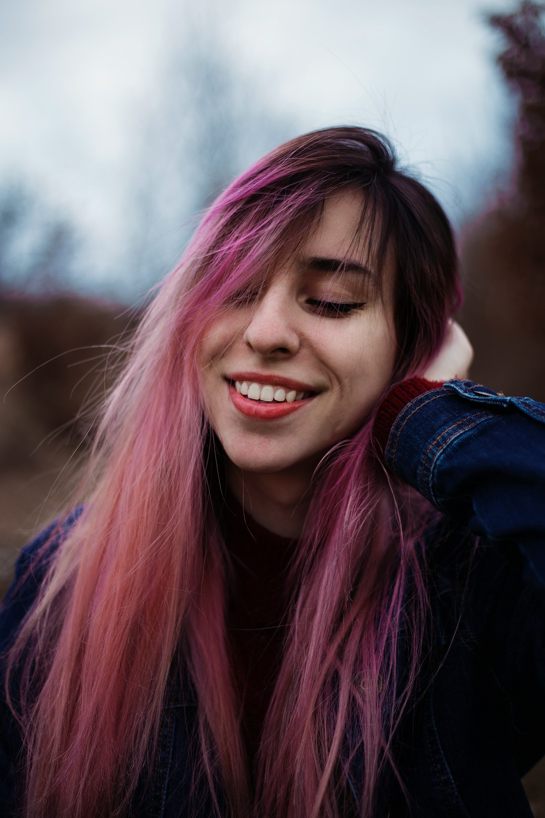 smiling woman in blue denim jacket