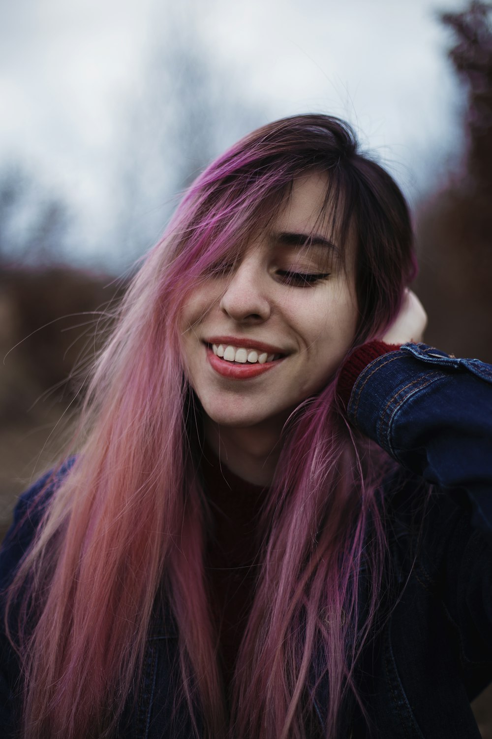 smiling woman in blue denim jacket