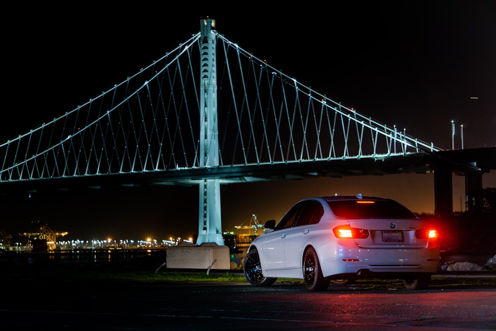 white car on bridge during night time