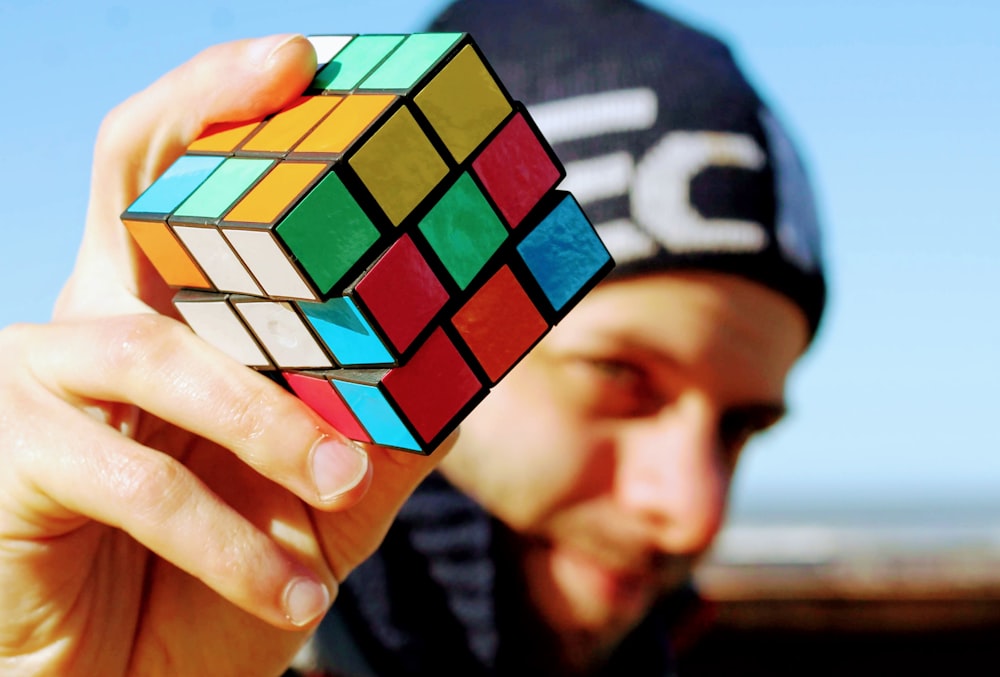 person holding 3 x 3 rubiks cube