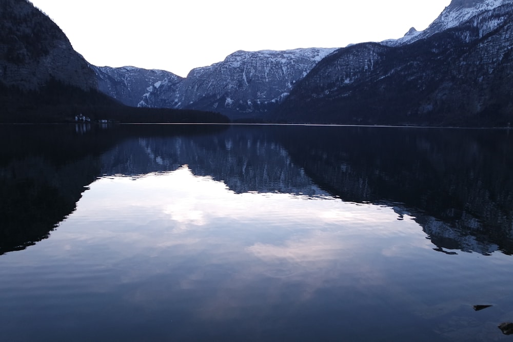 lake near mountain during daytime