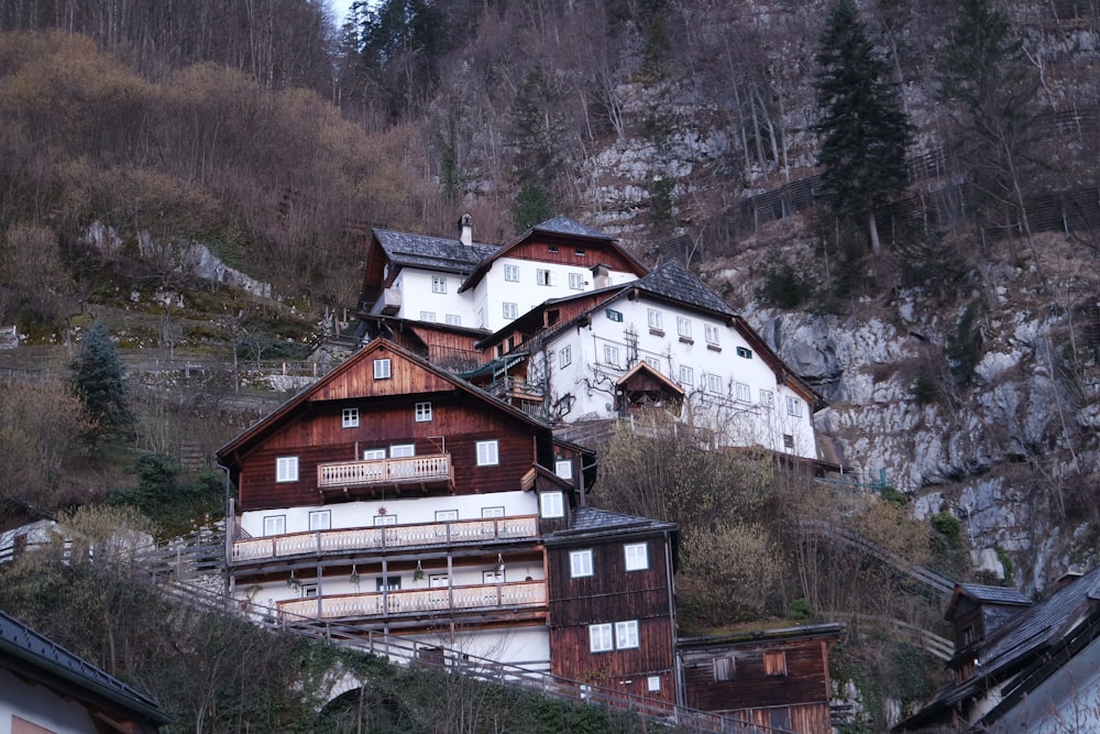 brown and white concrete house near green trees during daytime