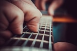 A close-up of guitar strings being played during a lively lesson.