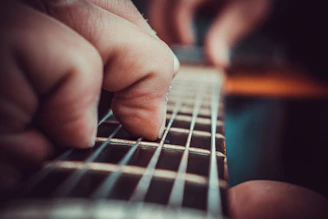 Close-up of Stewart’s fingers expertly dancing on the fiddle strings.
