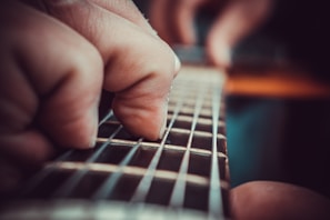 A close-up of guitar strings being played during a lively lesson.