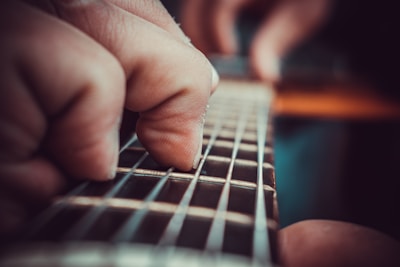 Close-up of the band’s guitarist mid-riff, fingers flying over the strings.